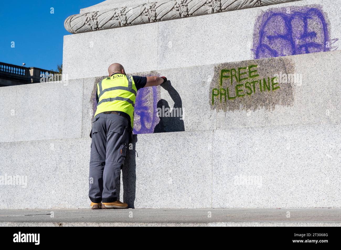 London UK 22 October 2023 A Workman Cleans Graffiti From The Base Of london-uk-22-october-2023-a-workman-cleans-graffiti-from-the-base-of
