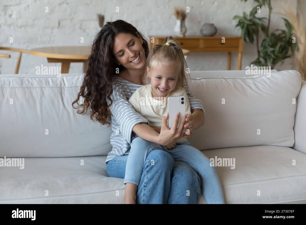 Happy mom holding cheerful adorable little daughter kid in arms Stock ...