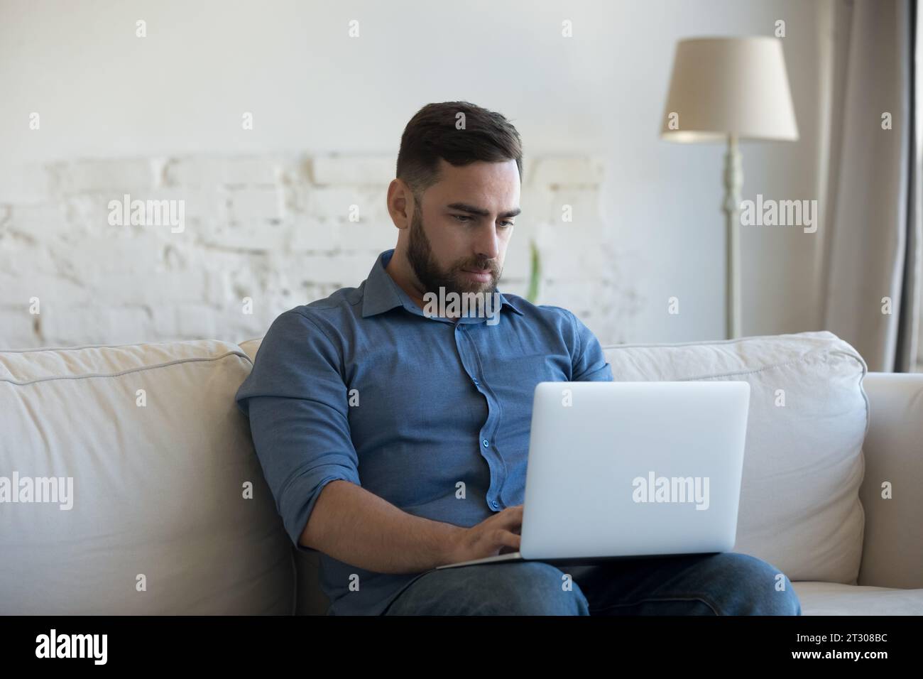 Focused laptop user freelancer man working from home Stock Photo