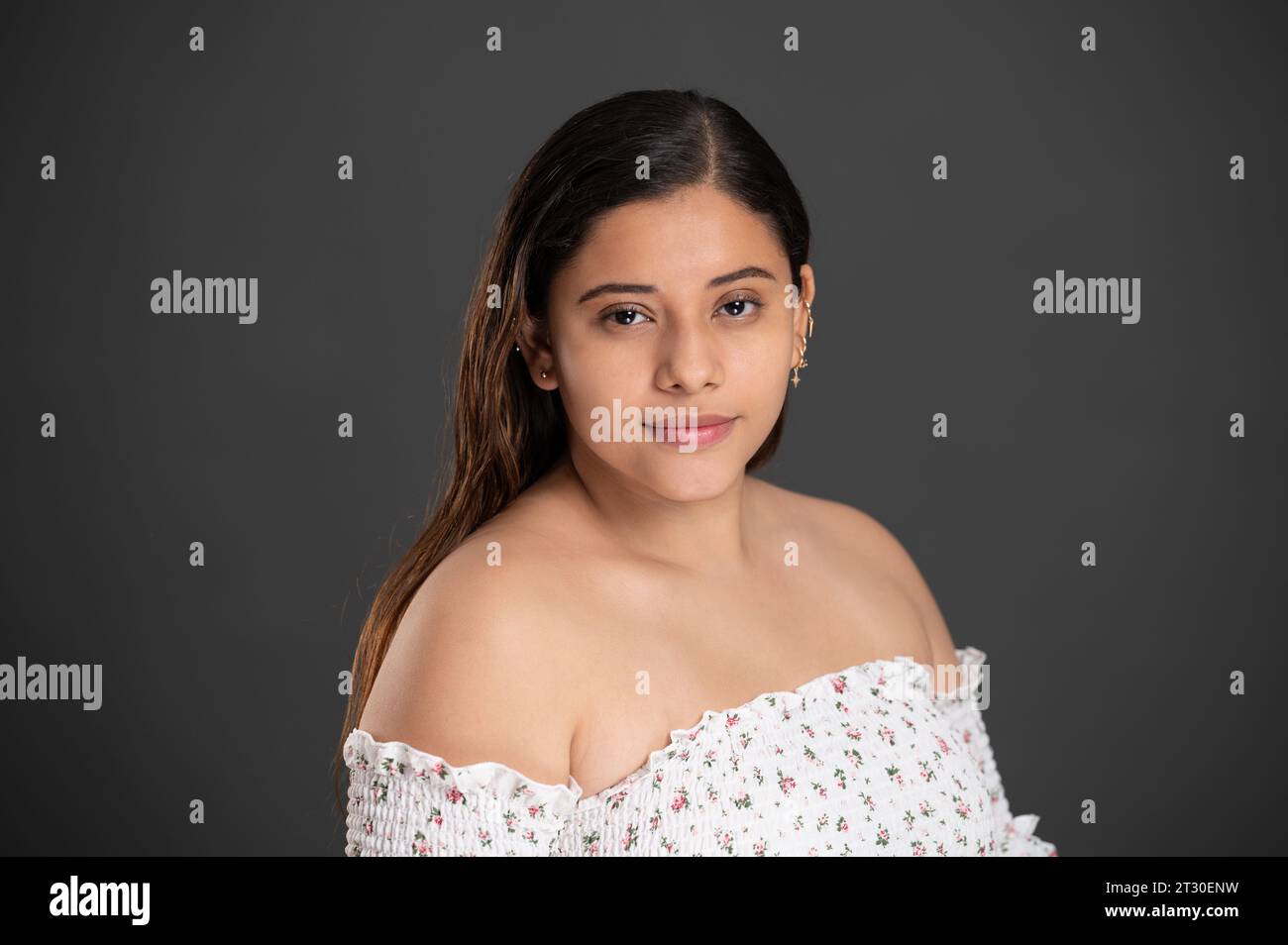 Headshot of young woman with ear piercing  on studio background Stock Photo