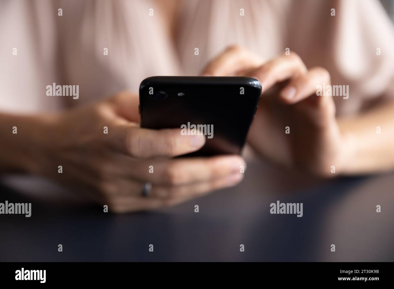 Close up view female hands holding black smartphone Stock Photo