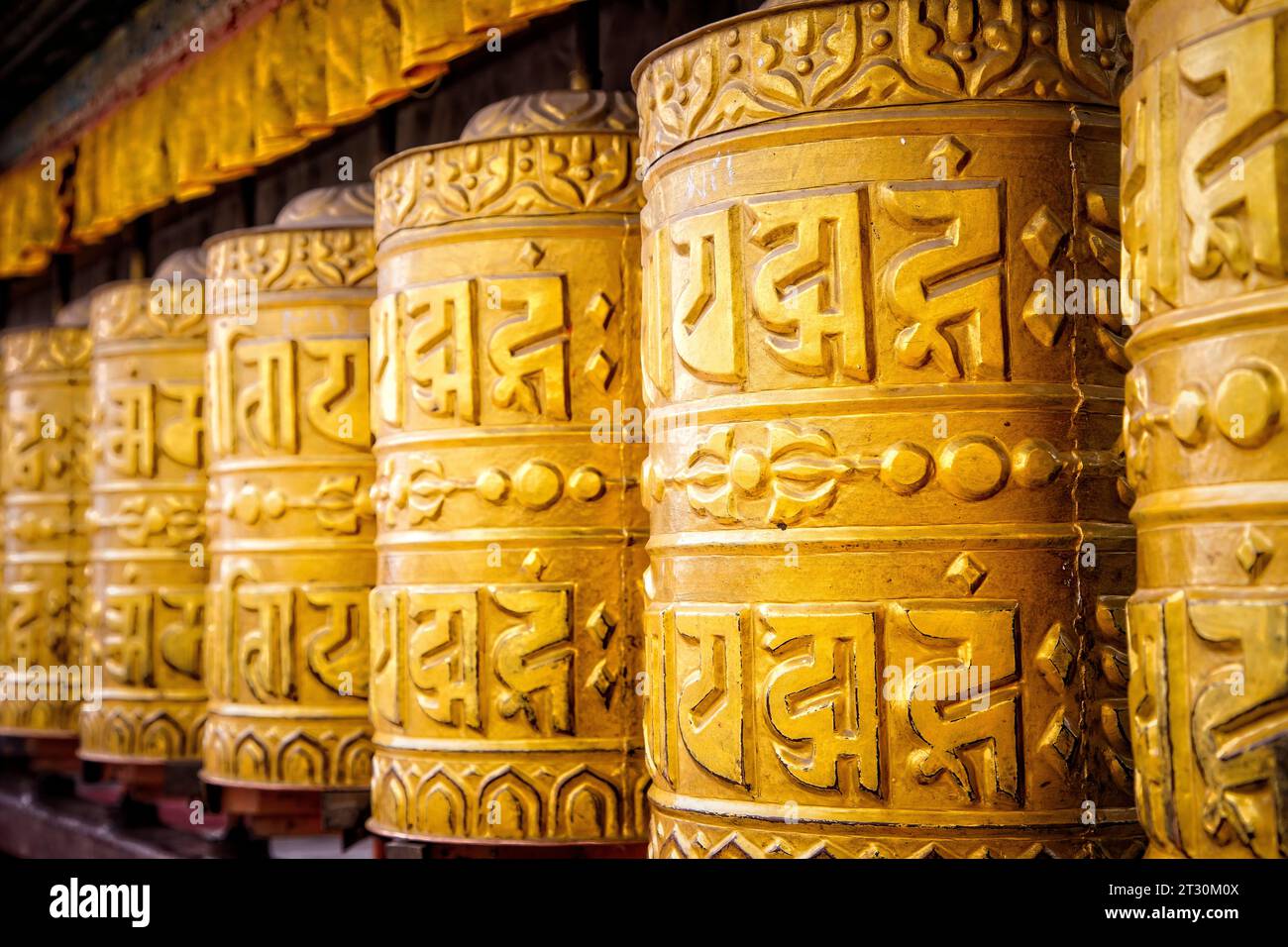 Golden prayer wheels stand ready at the Monkey Temple in Kathmandu ...