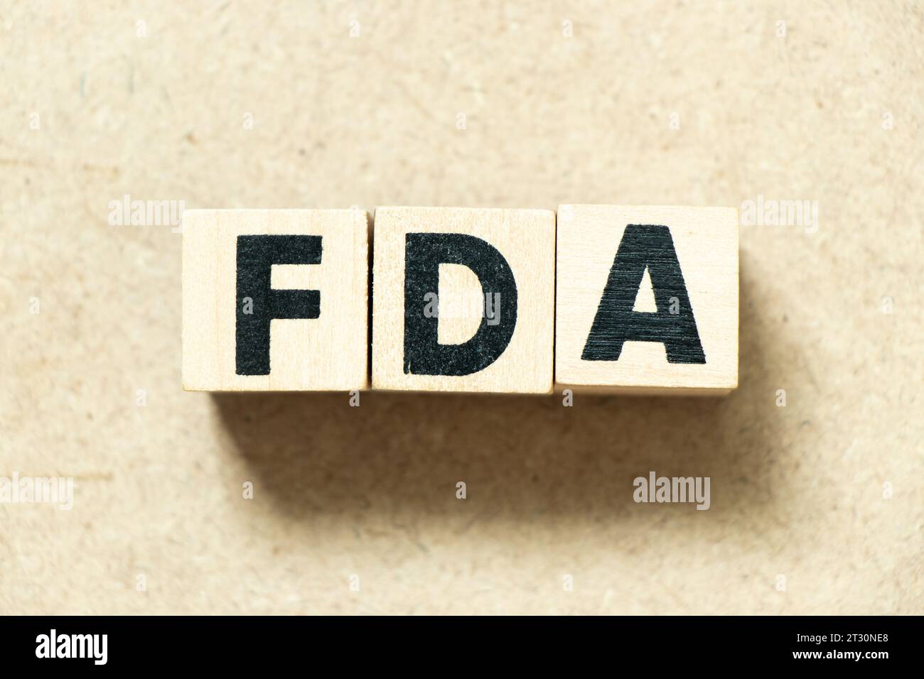 Alphabet letter block in word FDA (abbreviation of food and drug administration) on wood background Stock Photo