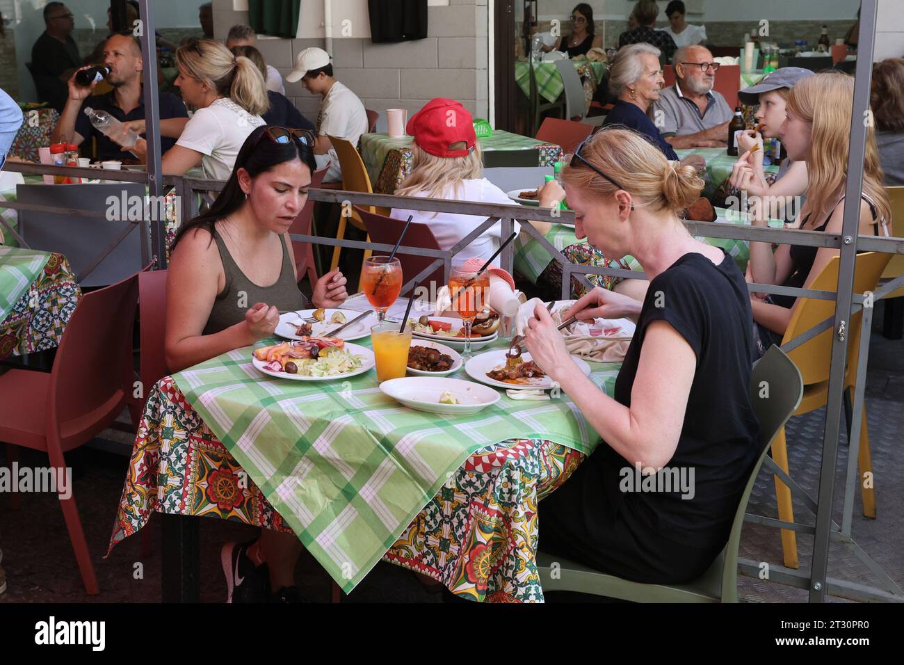 Diners eatng at a cafe in the Ballarò market in Palermo, Sicily, Italy Stock Photo