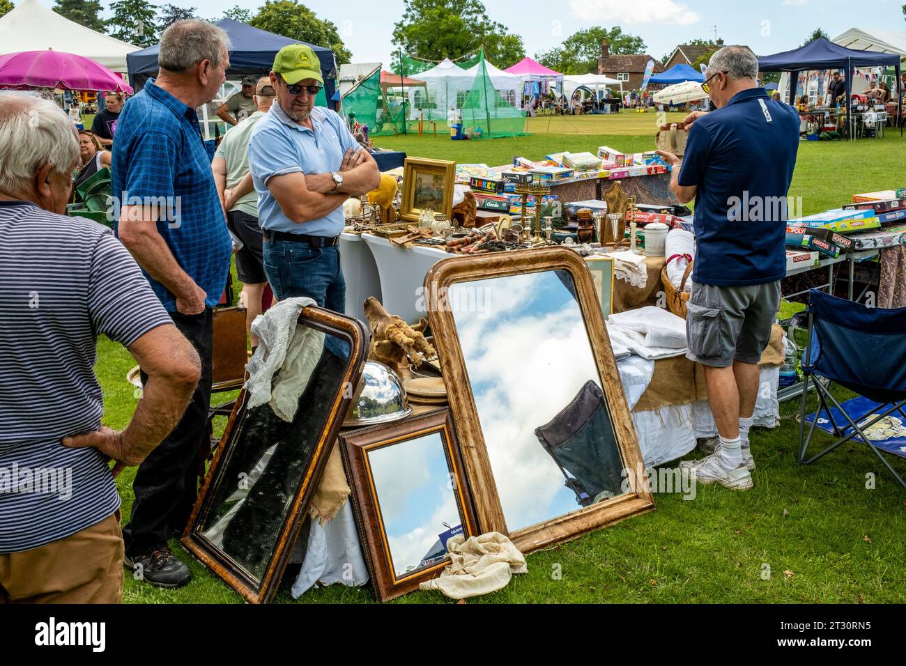 People Gather Around A Bric a Brac Stall At The Annual Nutley Village Fete, Nutley, East Sussex, UK. Stock Photo