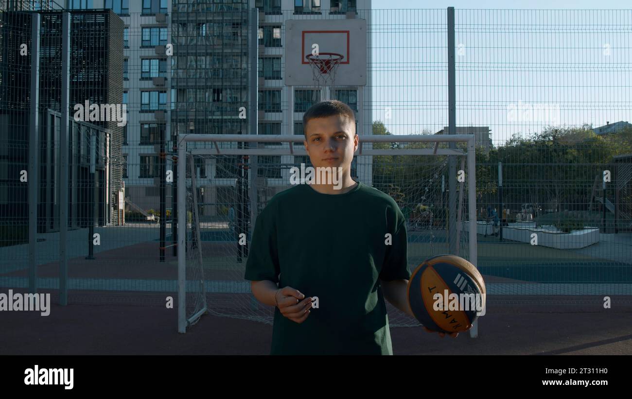 A handsome male athlete. Media. A man standing on a volleyball court