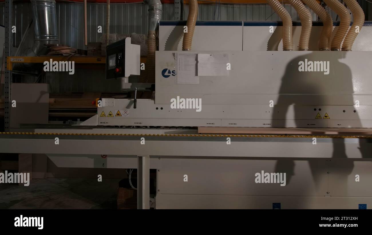 https://c8.alamy.com/comp/2T312XH/delhi-india-april-29-2023-woodworking-machineries-creative-carpentry-factory-with-a-worker-and-wooden-boards-processing-machine-2T312XH.jpg