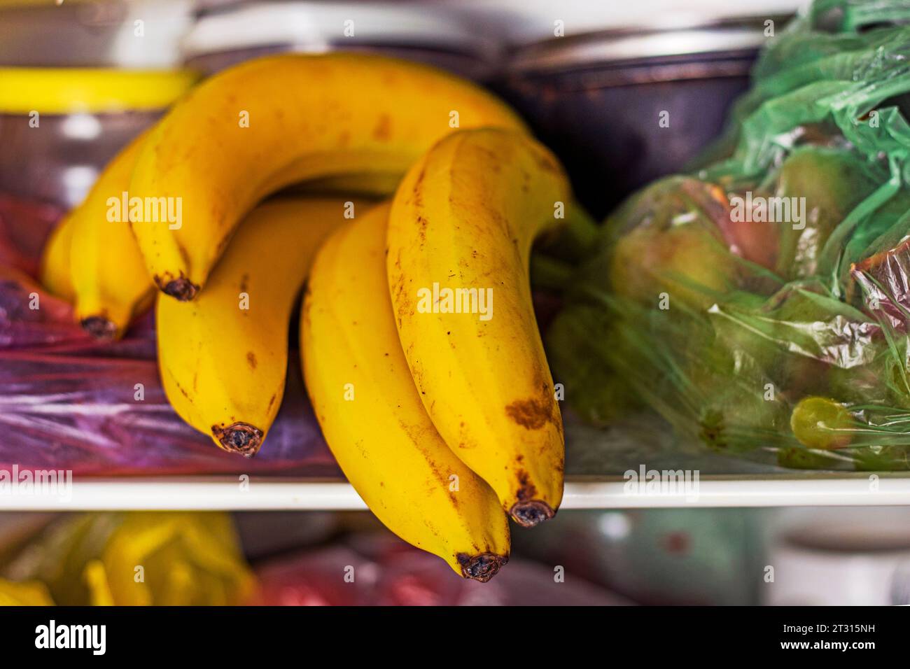 bunch of ripe yellow bananas in the refrigerator on a shelf Stock Photo Alamy