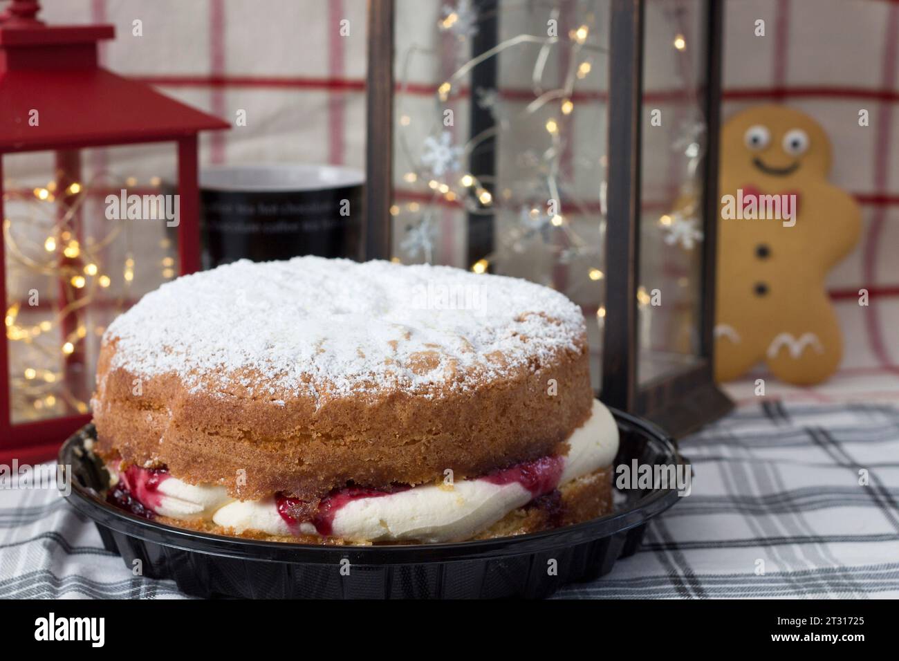 https://c8.alamy.com/comp/2T31725/gingerbread-man-looking-longingly-at-a-large-jam-and-cream-cake-2T31725.jpg