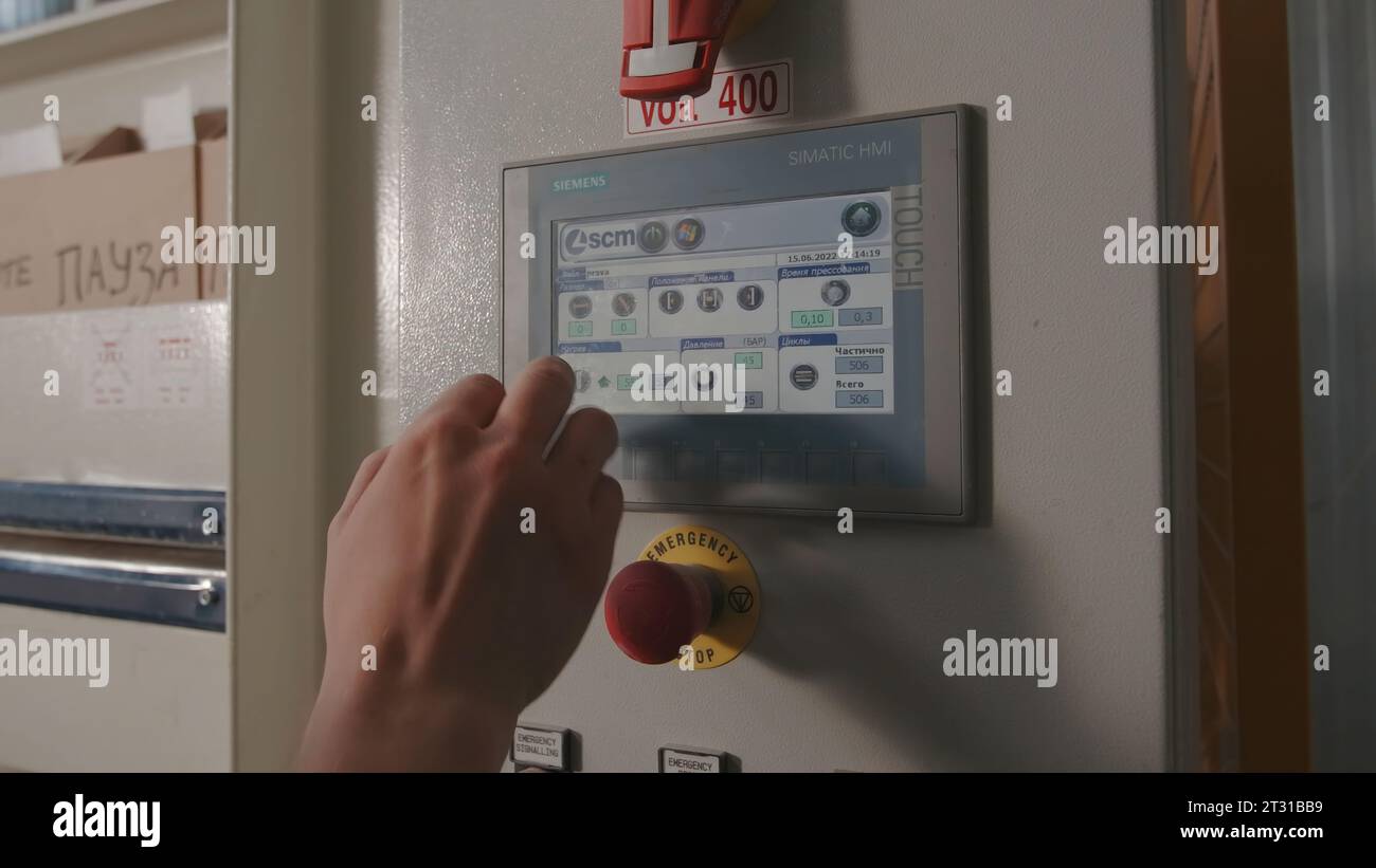 Man pressing buttons on machine hi-res stock photography and images - Alamy