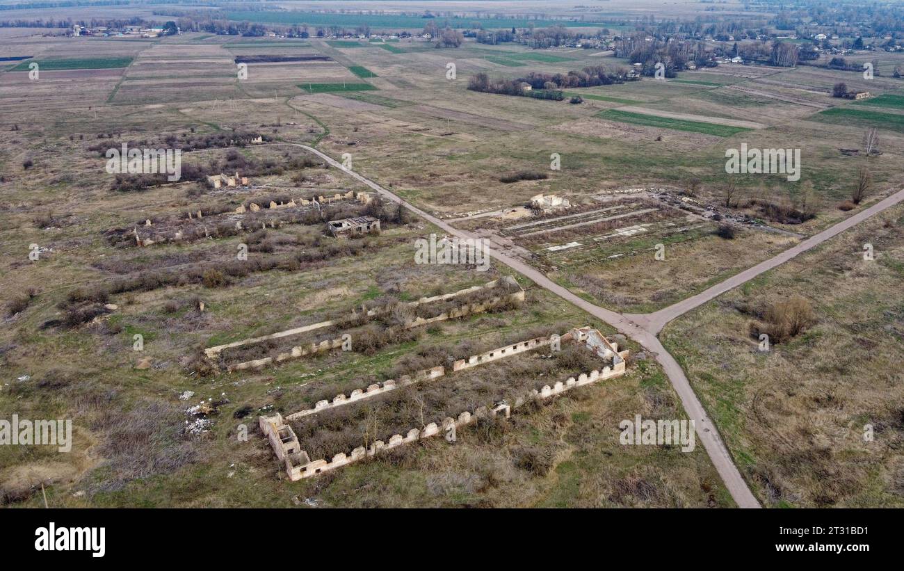 Destroyed agricultural buildings, aerial view. Abandoned livestock farm. Stock Photo