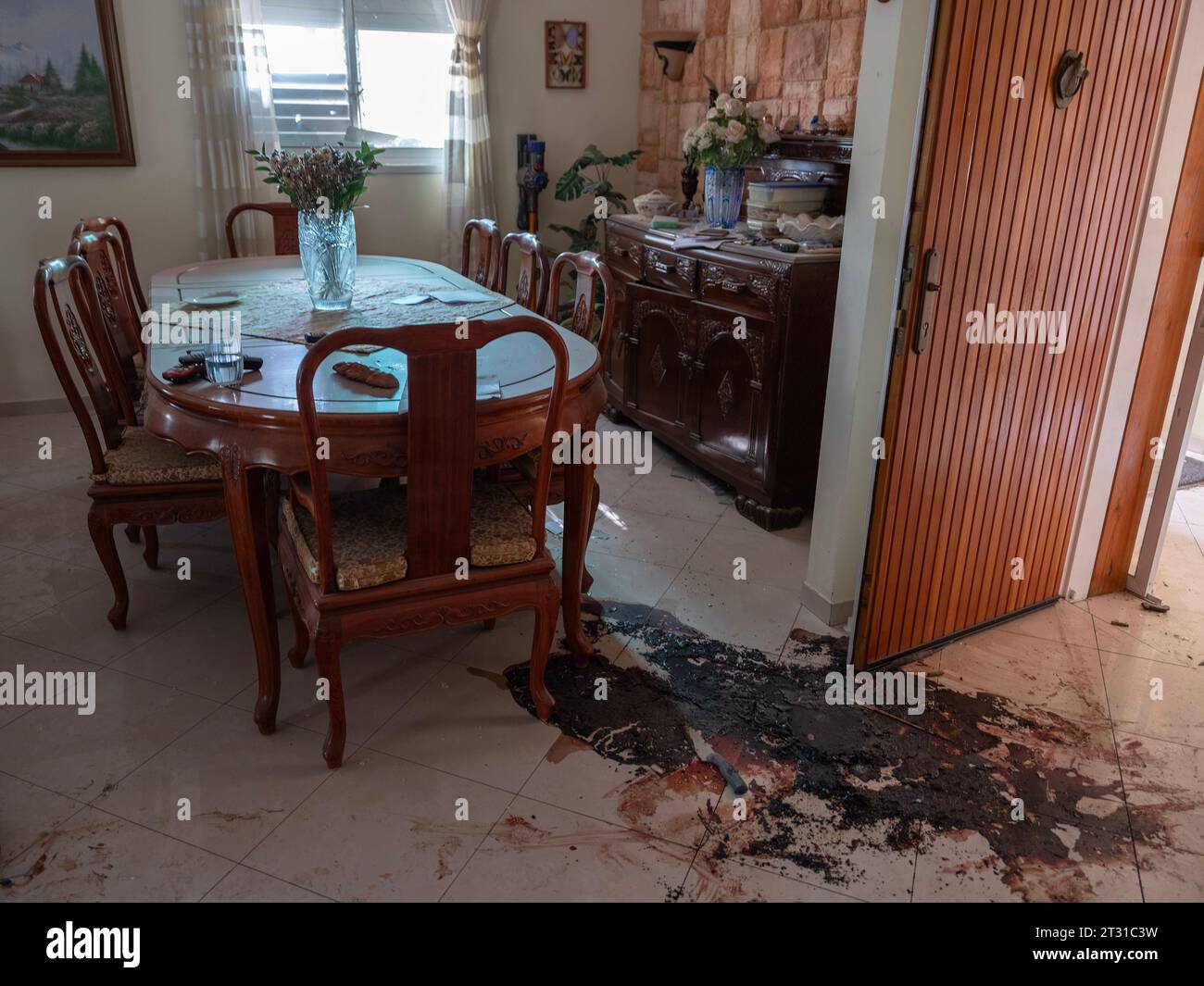A large pool of blood with a stained kitchen knife in it is seen next to a dining room table complete with a vase of flowers in an attacked civilian home in the Jewish community of Kibbutz Be'eri, along the Gaza Strip, on October 22, 2023. This community was attacked by Hamas infiltrators who killed some 100 people out of 1000 who lived in this community on October 7, 2023. Photo by Jim Hollander/UPI Credit: UPI/Alamy Live News Stock Photo