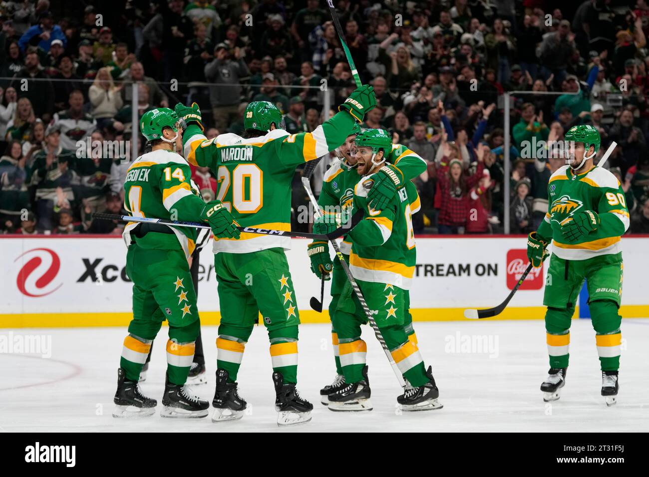 Minnesota Wild defenseman Dakota Mermis, center right, celebrates with