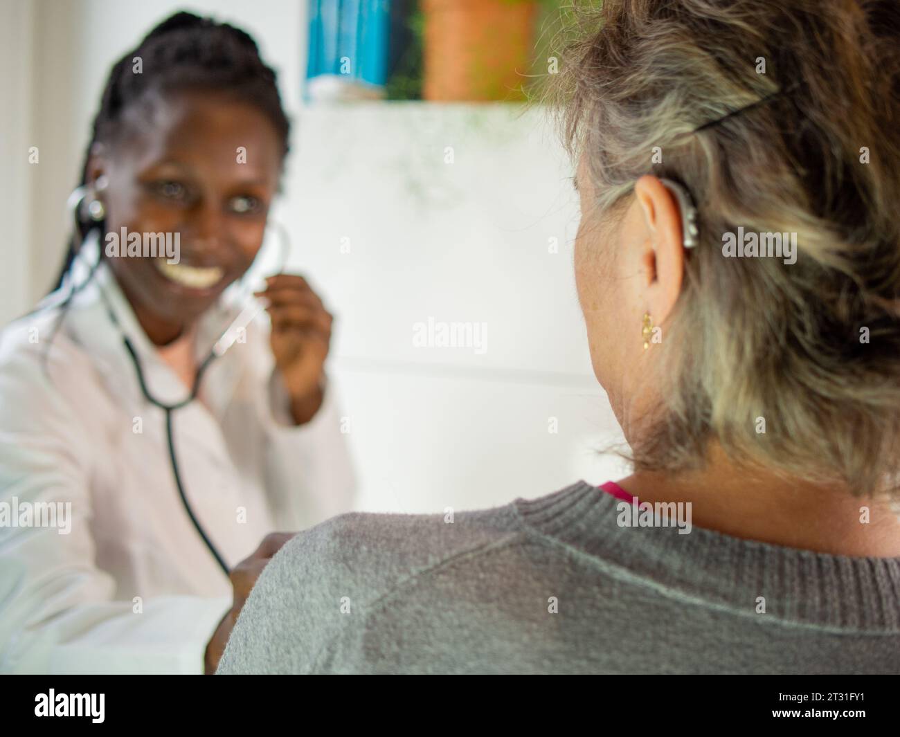 young female doctor ready to use a stethoscope with her patient Stock ...