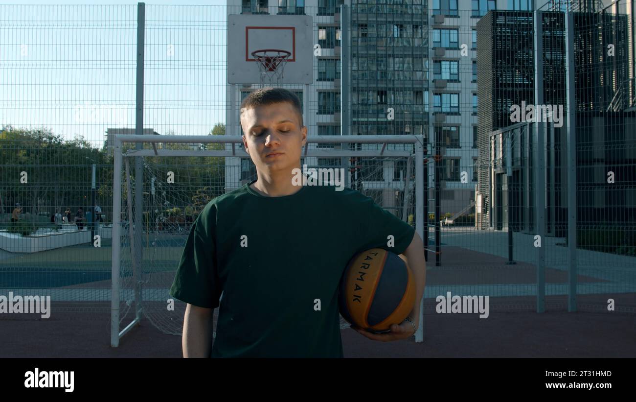 A handsome male athlete. Media. A man standing on a volleyball court