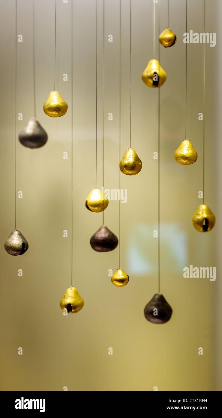 Bogota, Colombia - January 3, 2023: Bells of different materials hanging in the Gold Museum Stock Photo