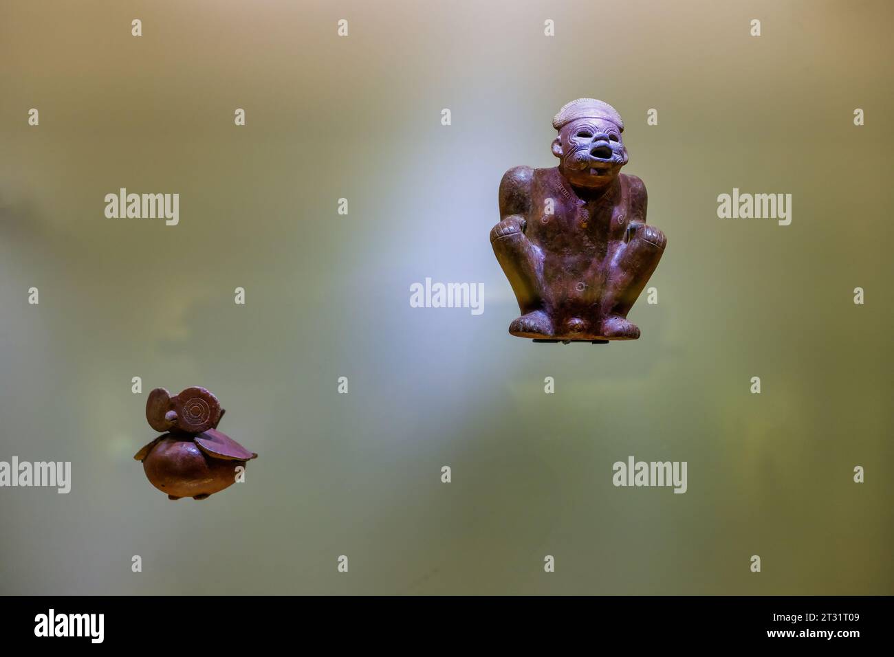Bogota, Colombia - January 3, 2023: Ceramic figures of owl and shaman exposed in the Gold Museum Stock Photo