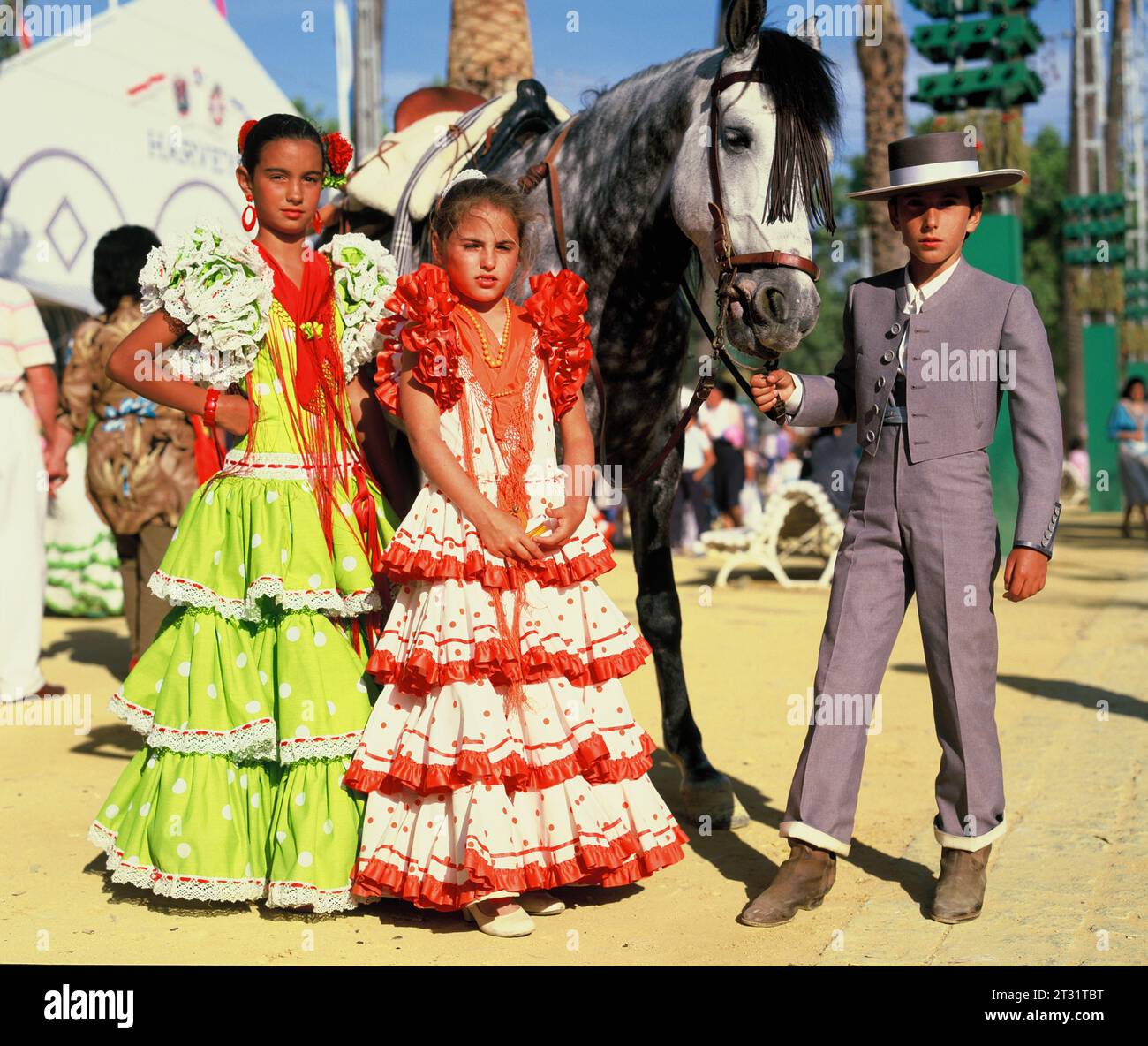 Spain. Cadiz region. The Jerez Horse Fair.  Two girls & boy in traditional clothes with horse. Stock Photo
