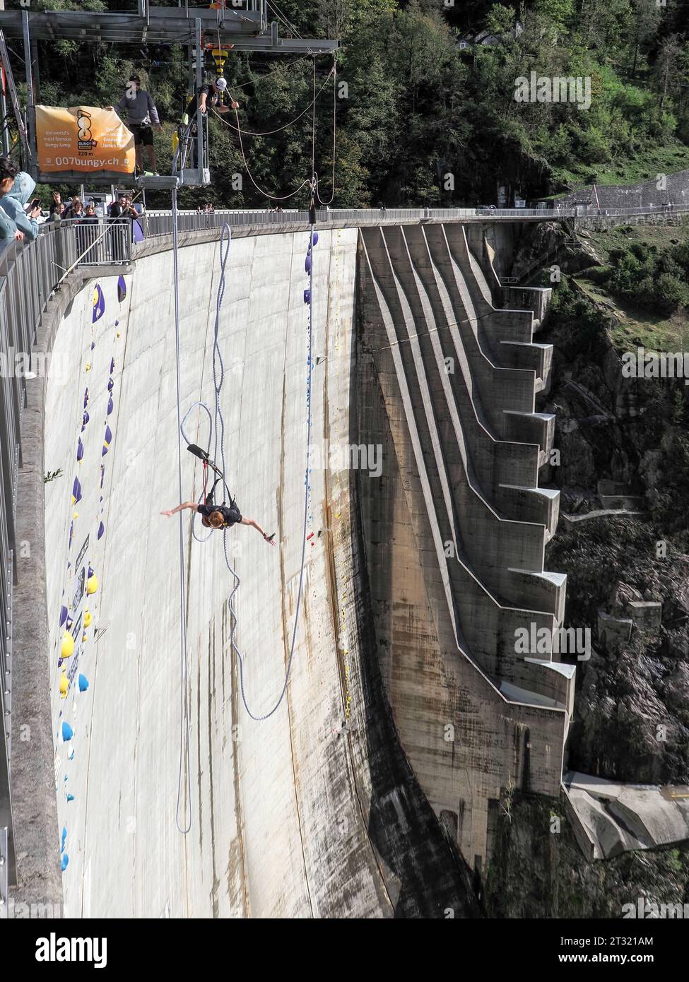 Contra Dam, Switzerland - October 22, 2023: Bunging jumping from the dam, 'The sign shows the name of the proposed activity' Stock Photo