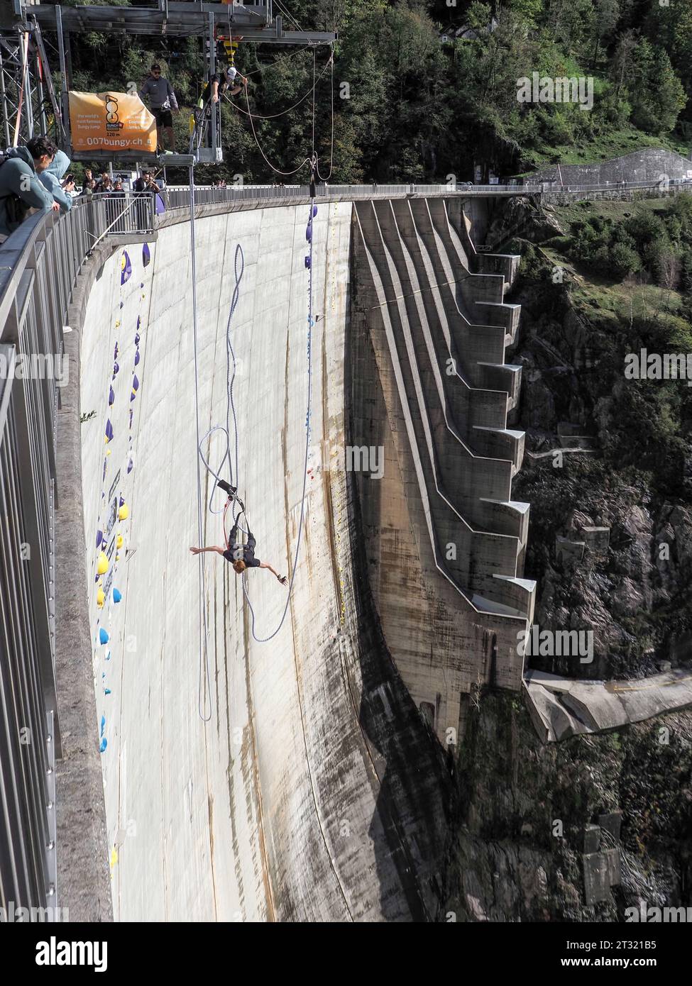 Contra Dam, Switzerland - October 22, 2023: Bunging jumping from the dam, 'The sign shows the name of the proposed activity' Stock Photo