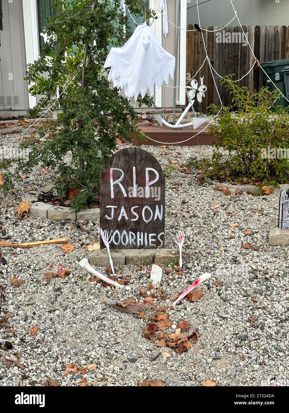 A tombstone with Rip Jason Voorhies on it are in a front yard