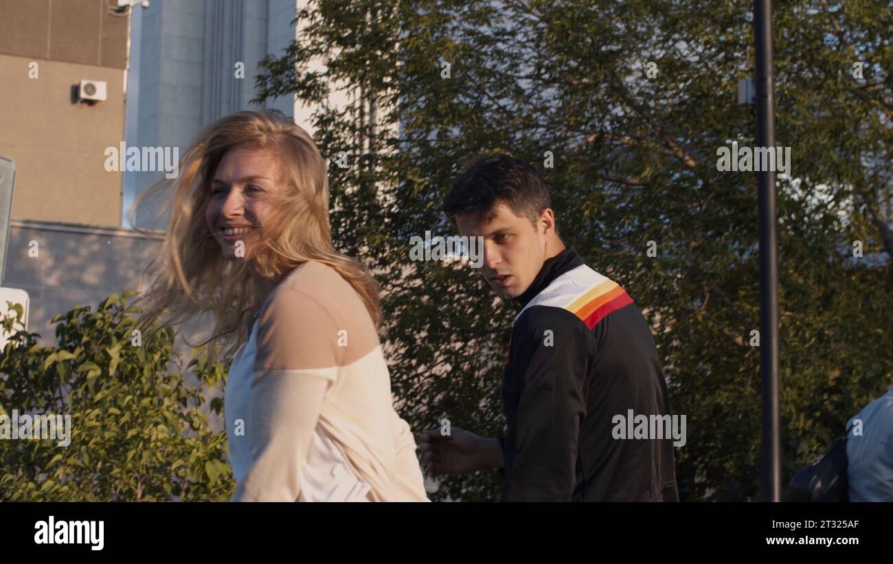 Energetic dancing. Stock. Two young people dance in summer weather against the backdrop of a megalopolis. Stock Photo