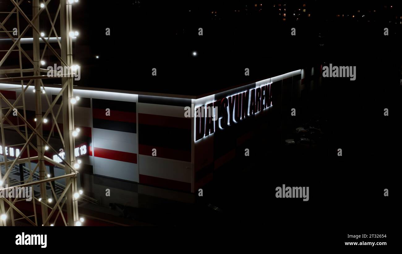 Dark view from the drone on the store. Stock footage. An illuminated shop with bright letters and towers with lanterns. Stock Photo