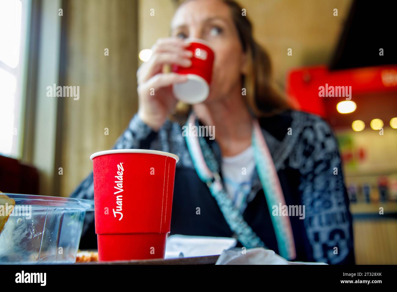 Bogota, Colombia - January 1, 2023: Woman drinks coffee in a Juan Valdez store, in the district of La Candelaria Stock Photo
