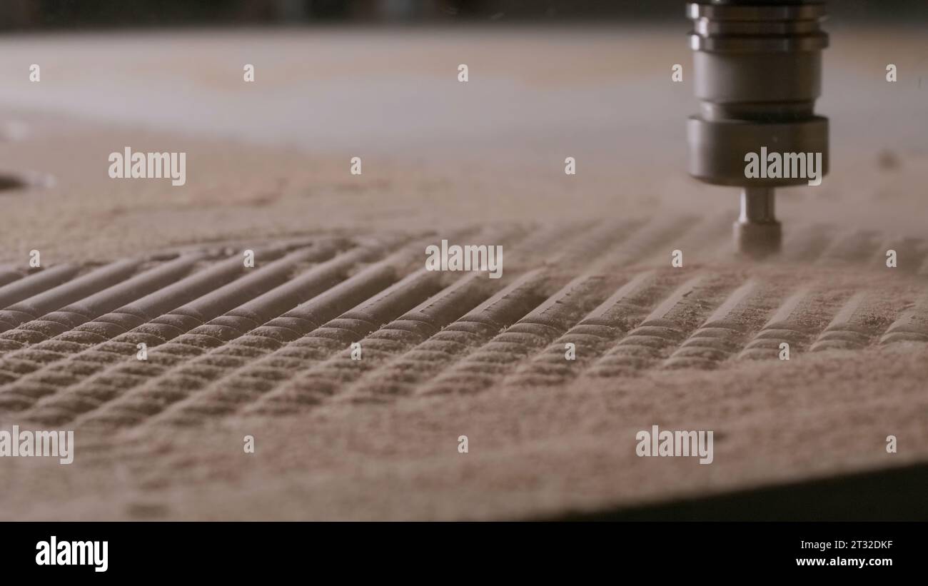 Engraving machine carving wood board. Creative. Automatic machine cutting wooden surface and creating a pattern. Stock Photo
