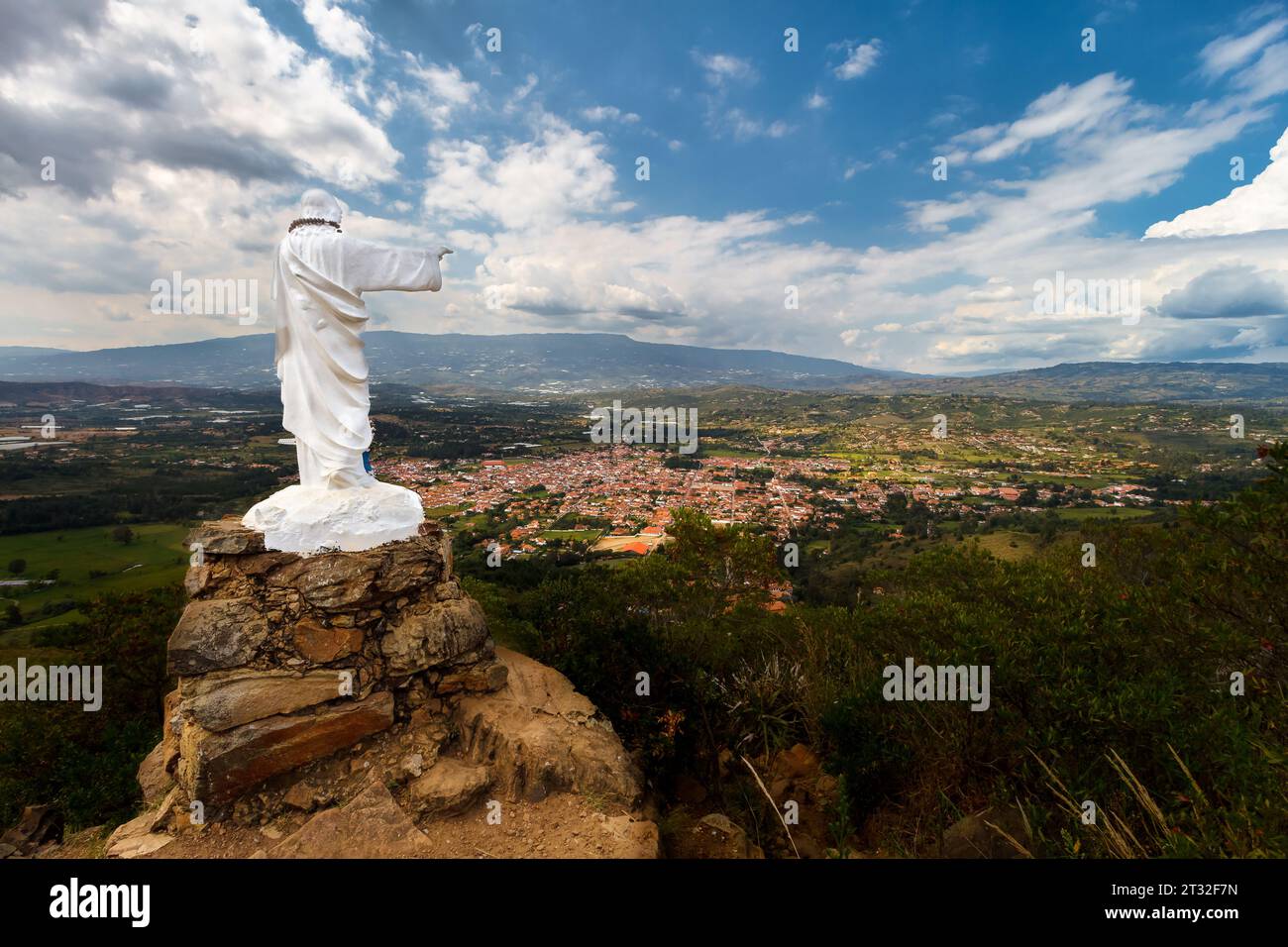 Statue of Jesus on top of a hill with a panoramic view of the Colombian