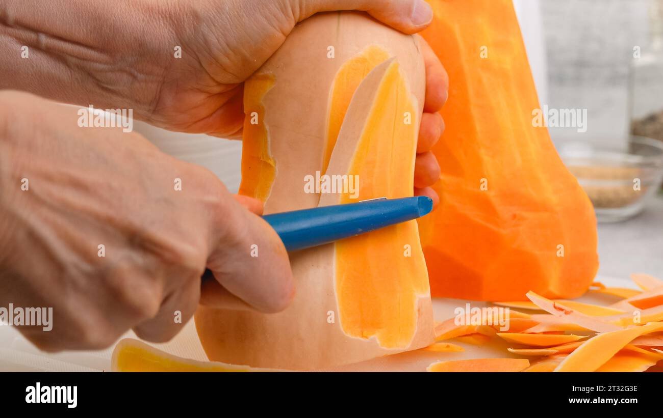 Butternut squash soup recipe, preparation process closeup. Woman hands