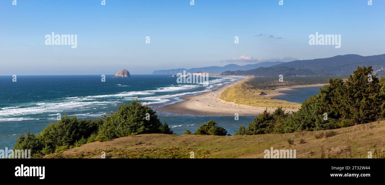 Scenic view from Porter Point with the confluence of  Nestucca River and the Pacific Ocean, Haystack Rock, and Cape Kiwanda State Natural Area Stock Photo
