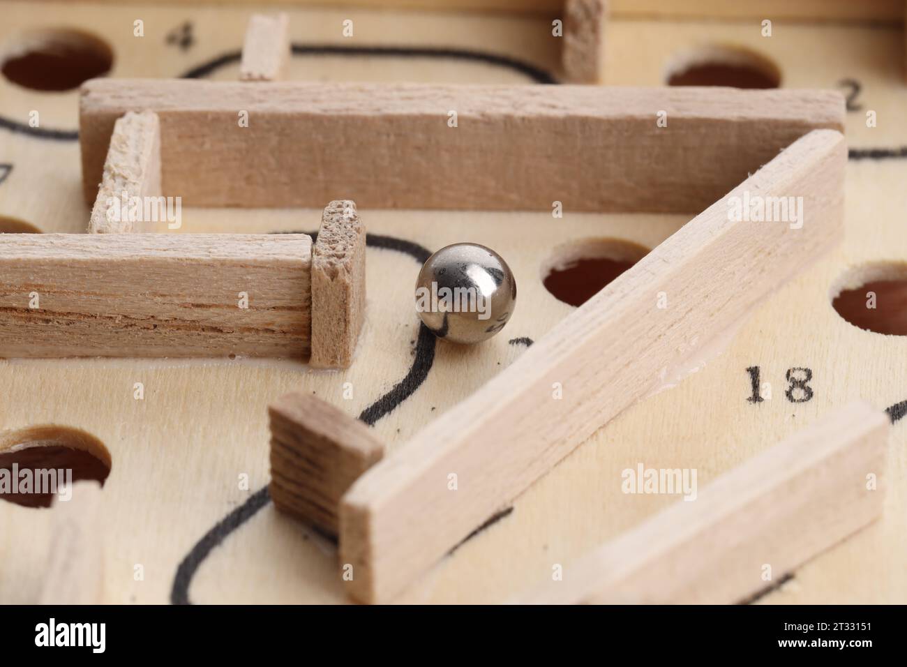 Wooden toy maze with metal ball, closeup Stock Photo