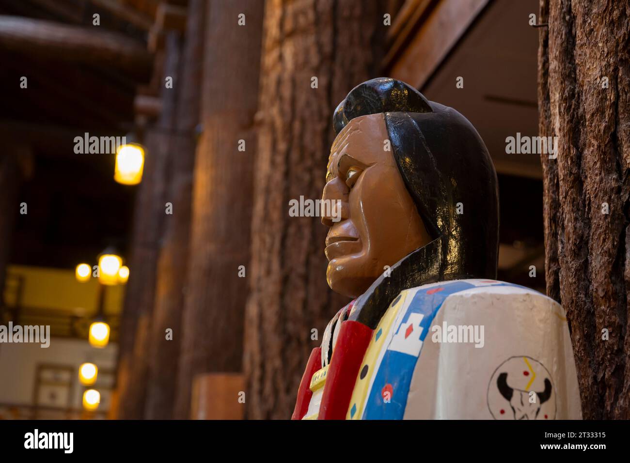 A traditional cigar store Indian greets visitors to Glacier Park Lodge in East Glacier Park, Montana. Stock Photo