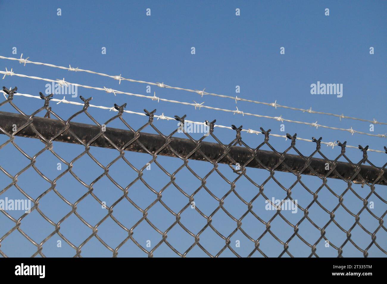 Chain link fence with barbed wire Stock Photo Alamy