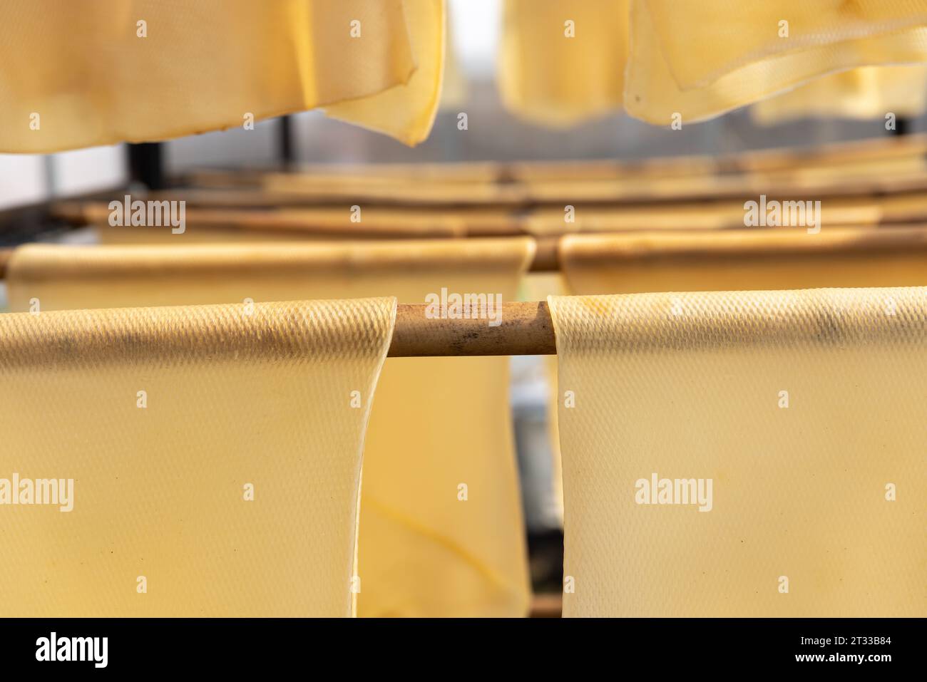 Rubber sheets hanging on rail for dry process air dried sheet (ADS) rubber method in solar