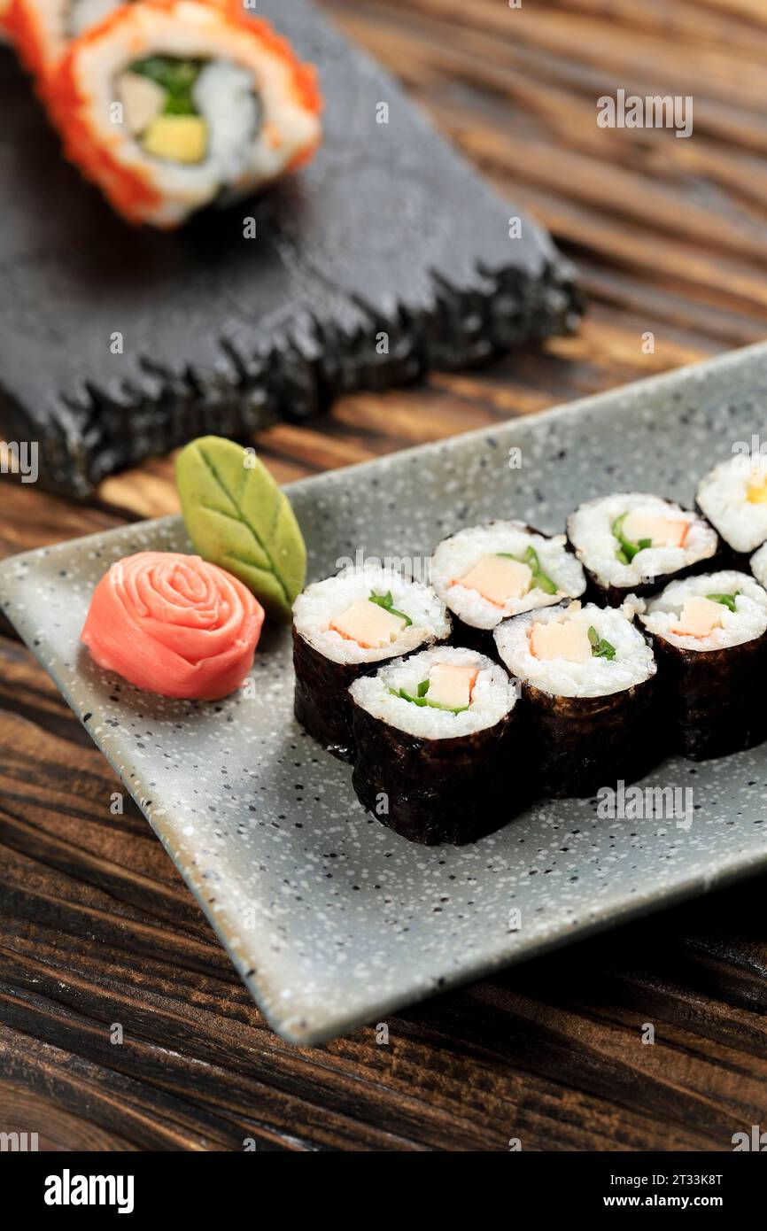One Bite Size Mini Maki Sushi with Crab Stick on Stone Plate Stock Photo