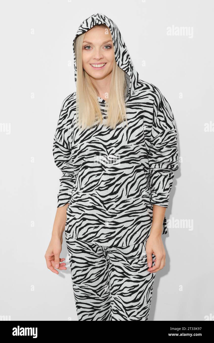 Beautiful woman in patterned zebra fleece suit with hood Stock Photo