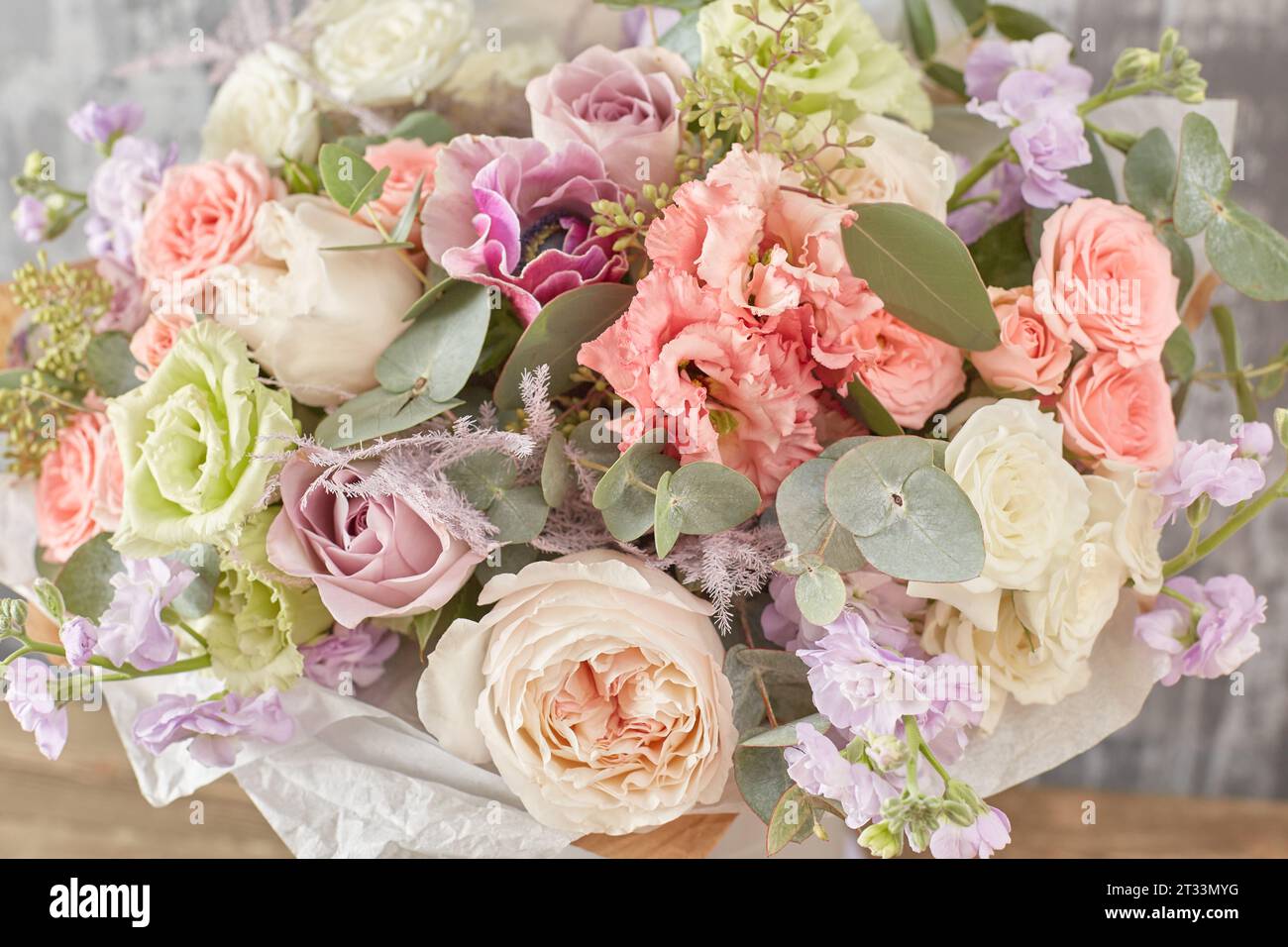 Small Beautiful bouquet of mixed flowers in woman hand. Floral shop concept . Beautiful fresh cut bouquet. Flowers delivery Stock Photo