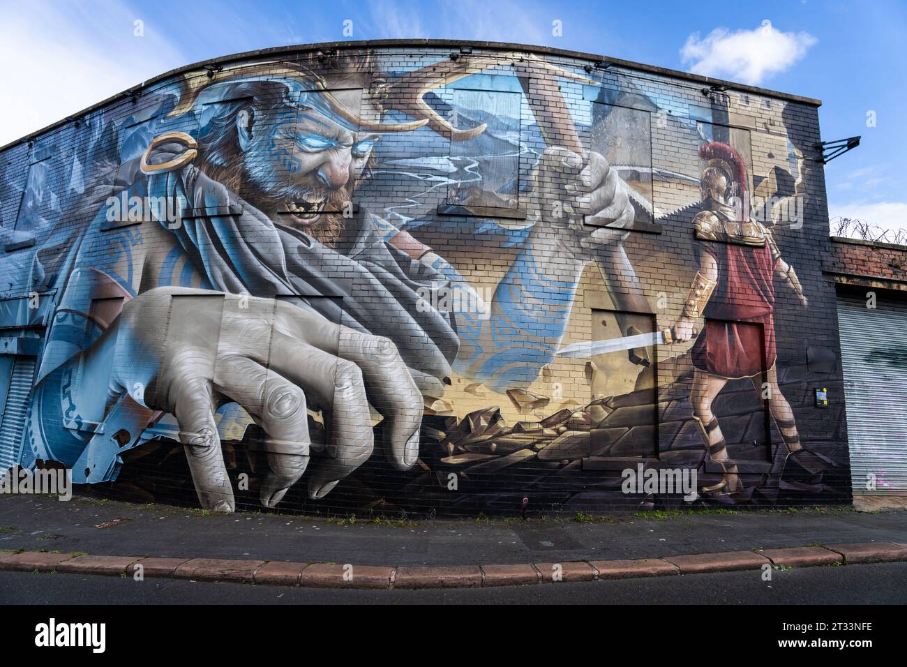 urban wall art depicting a Roman legionary fighting a celt or pict warrior or god, Carlisle, Cumbria, UK Stock Photo