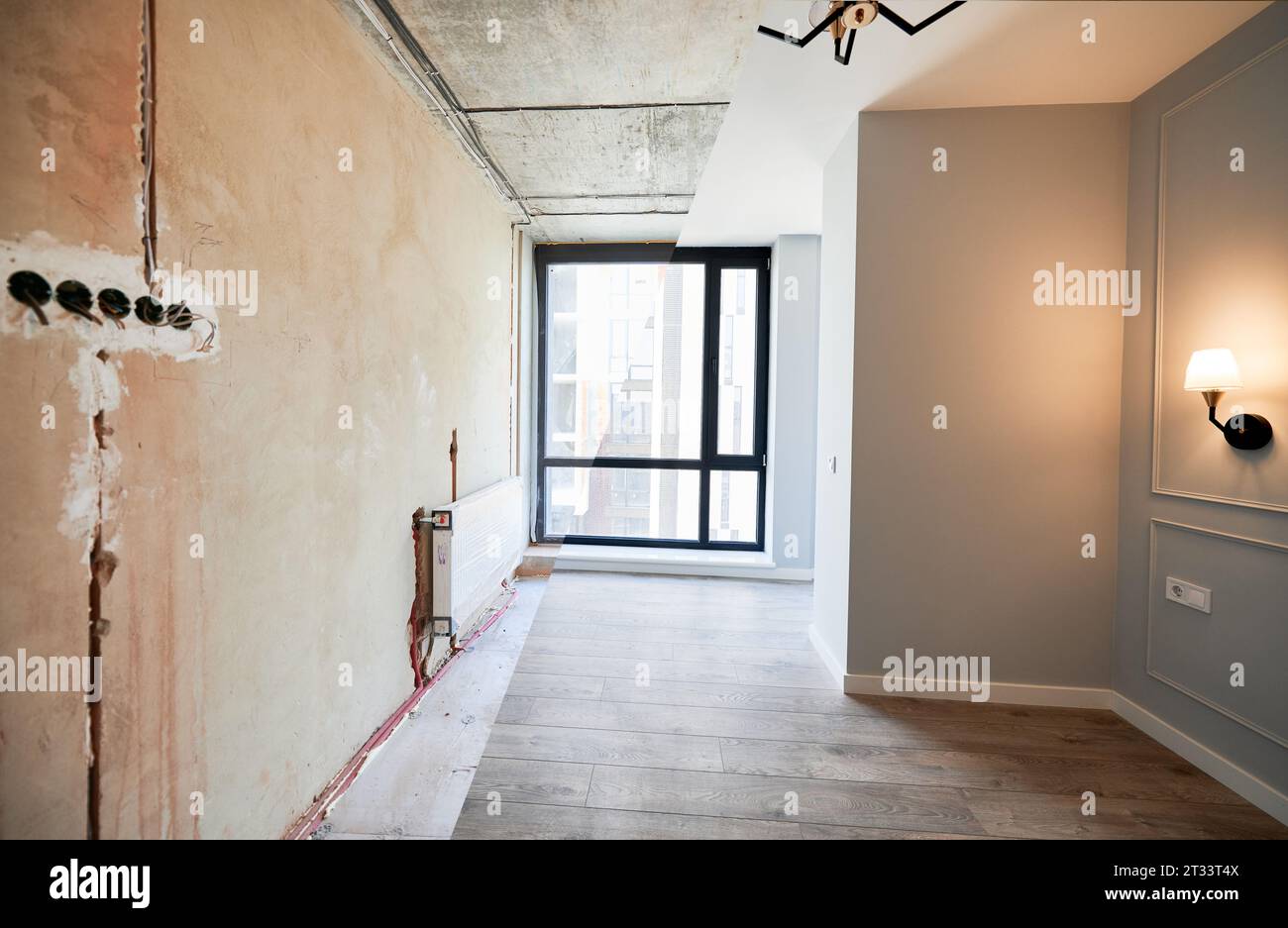 View of Comparison of living room with large panoramic window before and after ...