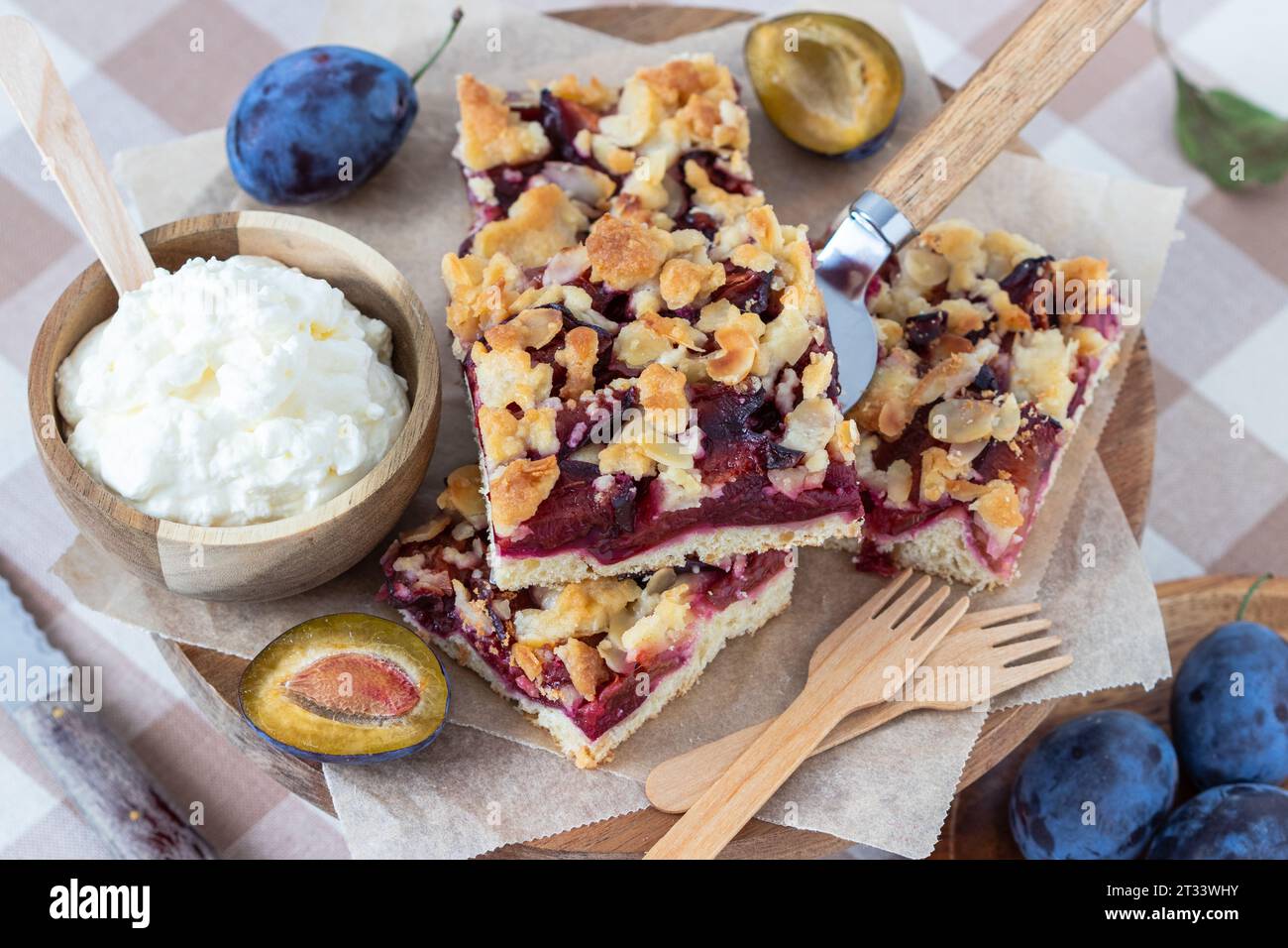 German plum sheet cake with butter crumble and whipped cream Stock Photo