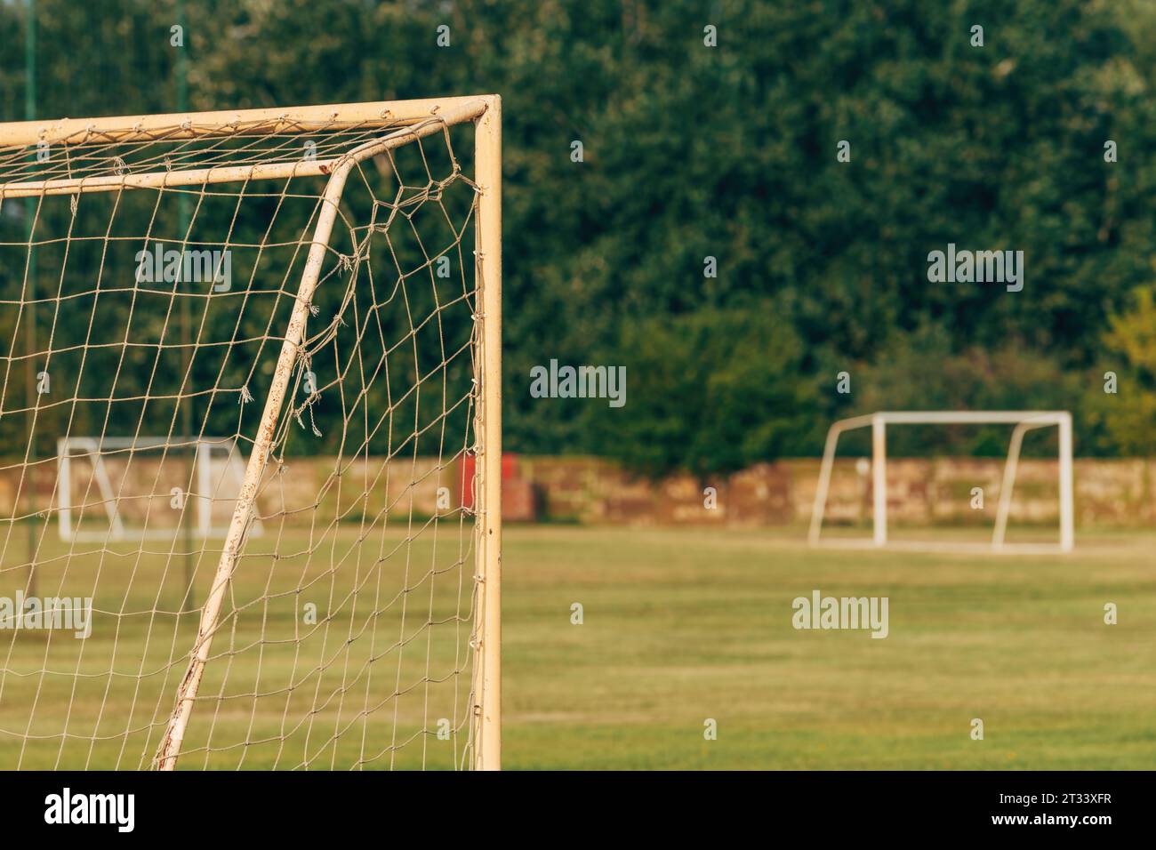 Soccer goal post and net on outdoor training pitch, selective focus Stock Photo