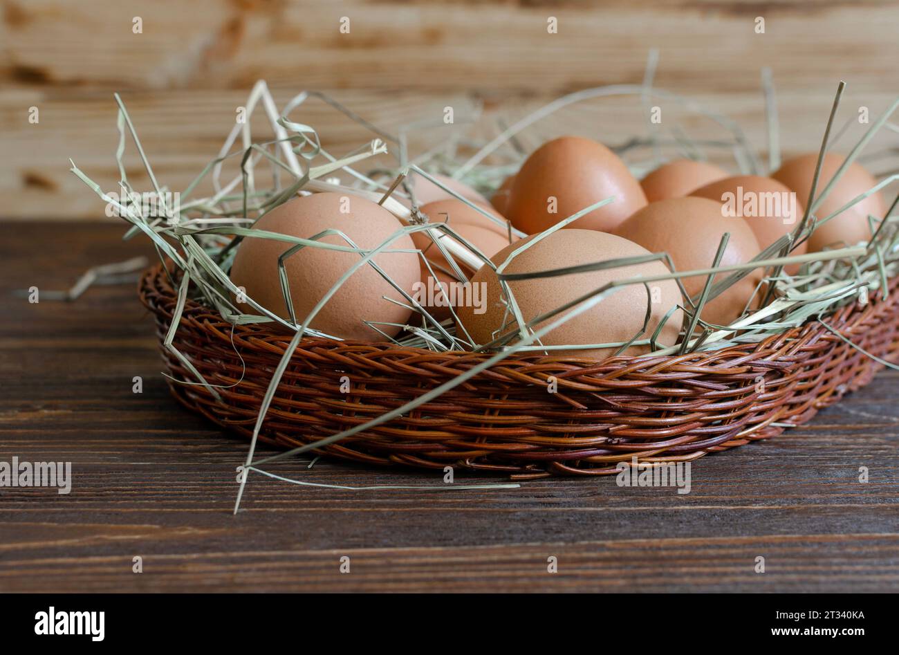 Fresh chicken brown eggs with hay on a wicker basket Stock Photo - Alamy