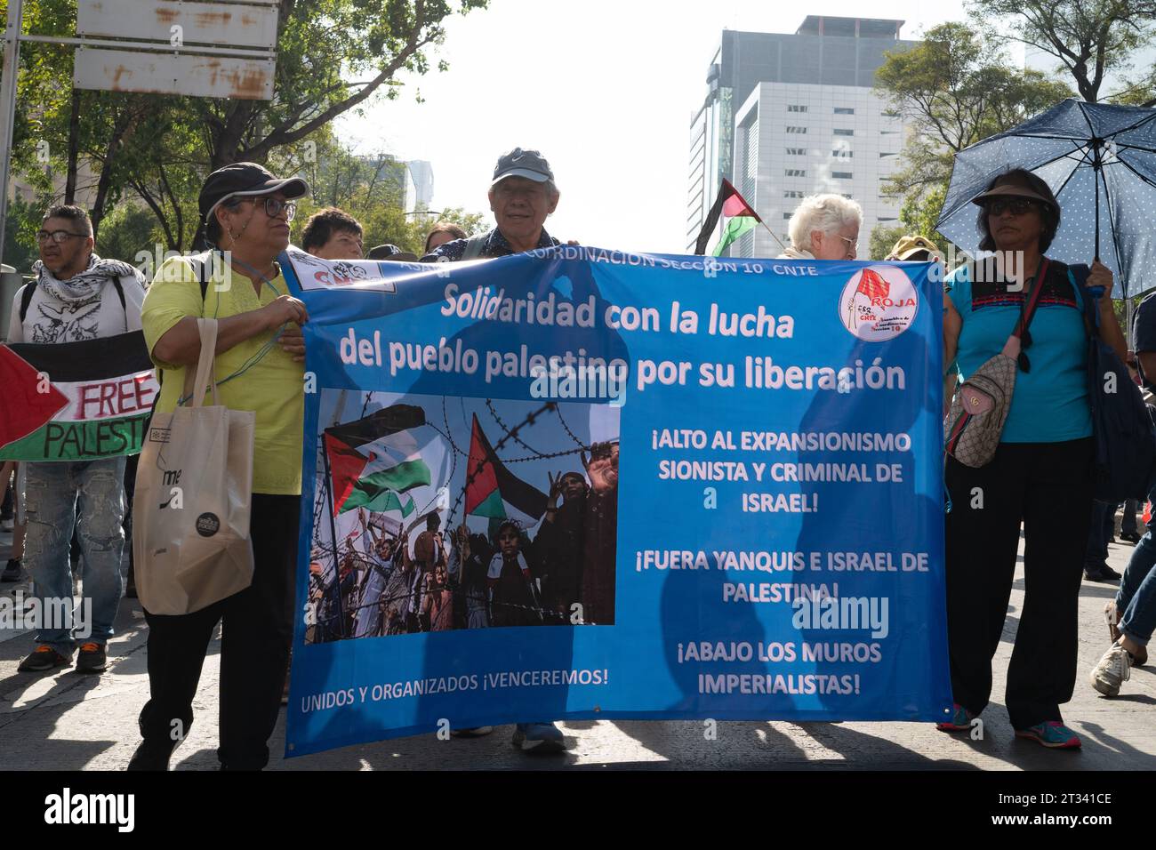 Pro-Palestine march, Mexico City, Mexico. 22nd Oct, 2023. protesters hold up banners showing support with Palestine. Thousands of people protest in Mexico City, whilst repeatedly chanting ÕItÕs not a war. ItÕs Genocide'. Many people waved Palestinian flags, others wore a keffiyeh in solidarity with the people of Palestine. Various groups formed part of the march including the Mexican Communist Party, pro-abortion activists and LGBTQ  groups. Credit: Lexie Harrison-Cripps/Alamy Live News Stock Photo