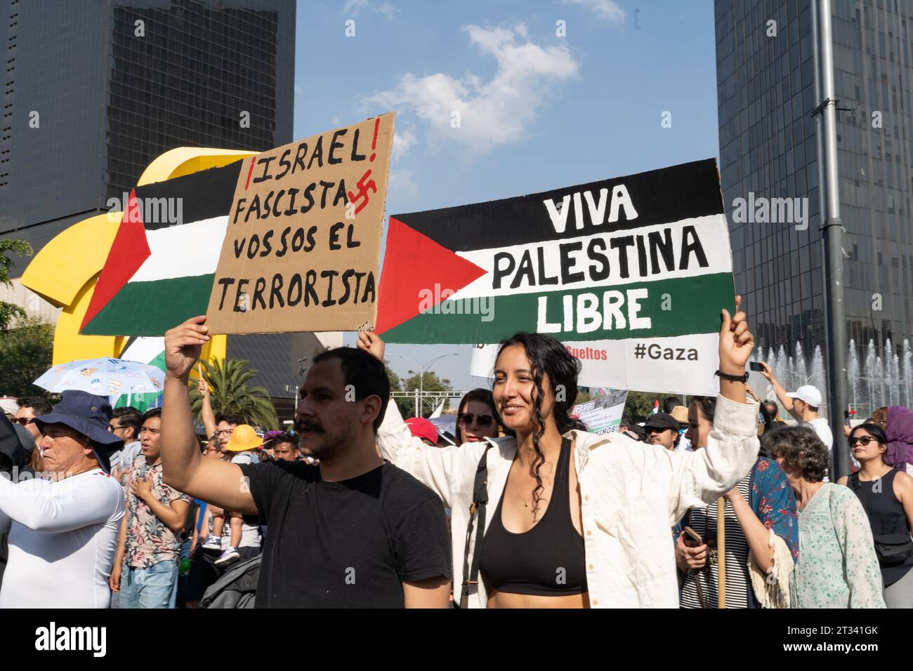 Pro-Palestine march, Mexico City, Mexico. 22nd Oct, 2023. protesters hold up signs accusing Israel of terrorism and free Palestine. Thousands of people protest in Mexico City, whilst repeatedly chanting ÕItÕs not a war. ItÕs Genocide'. Many people waved Palestinian flags, others wore a keffiyeh in solidarity with the people of Palestine. Various groups formed part of the march including the Mexican Communist Party, pro-abortion activists and LGBTQ  groups. Credit: Lexie Harrison-Cripps/Alamy Live News Stock Photo
