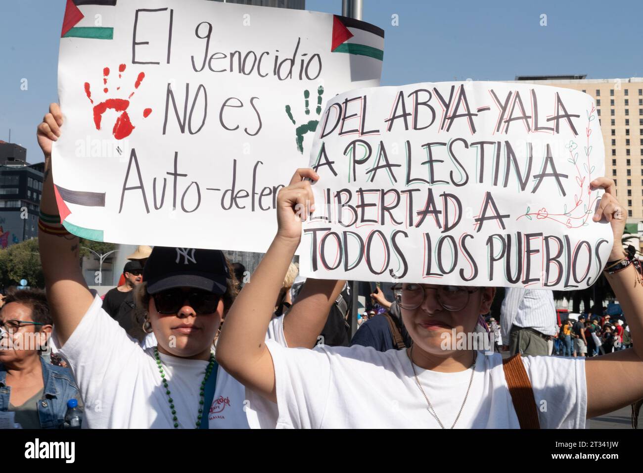 Pro-Palestine march, Mexico City, Mexico. 22nd Oct, 2023. protesters hold up signs saying 'Genocide is not self-defense'. Thousands of people protest in Mexico City, whilst repeatedly chanting ÕItÕs not a war. ItÕs Genocide'. Many people waved Palestinian flags, others wore a keffiyeh in solidarity with the people of Palestine. Various groups formed part of the march including the Mexican Communist Party, pro-abortion activists and LGBTQ  groups. Credit: Lexie Harrison-Cripps/Alamy Live News Stock Photo