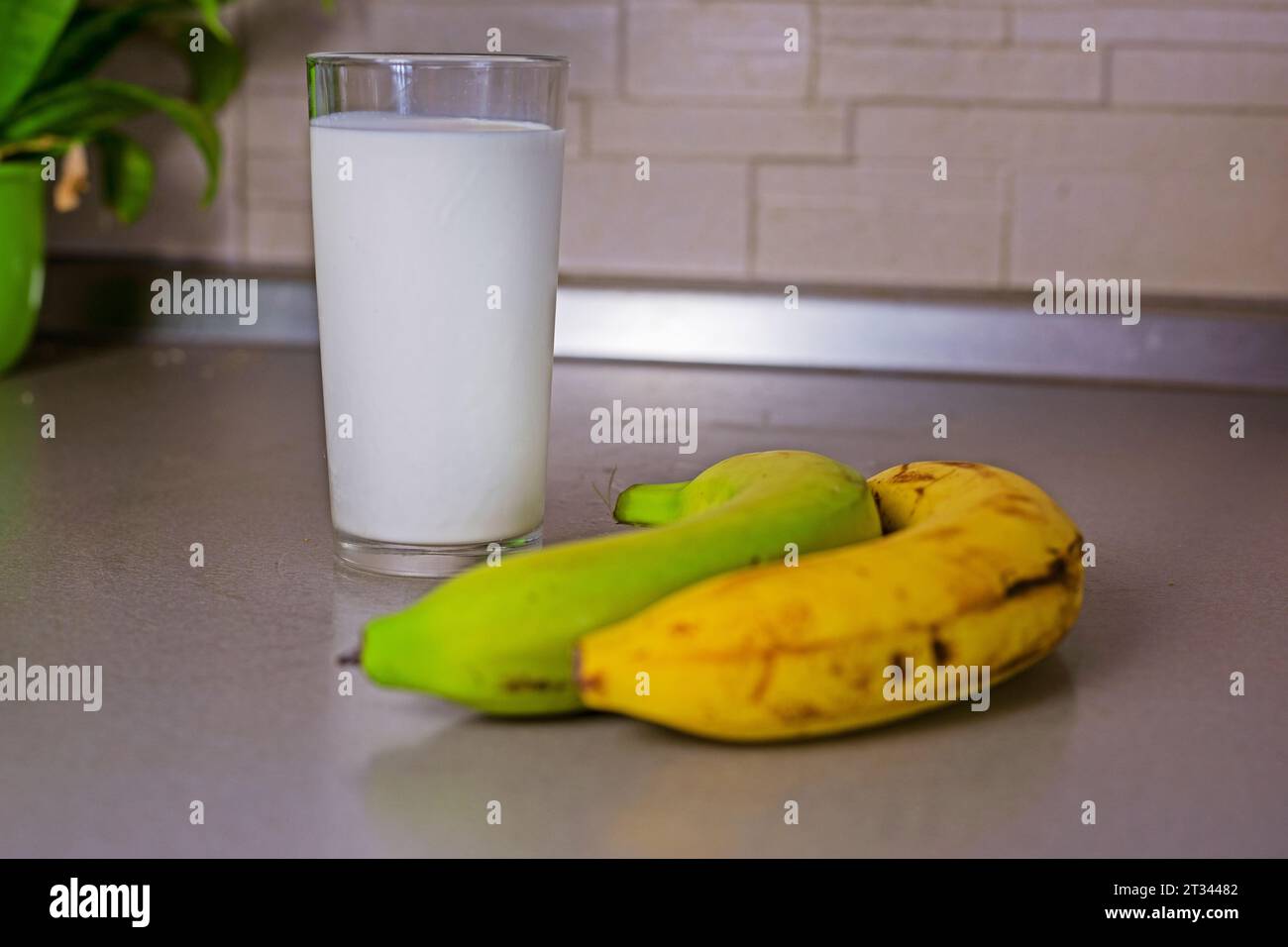 glass of banana milk next to bananas Stock Photo - Alamy