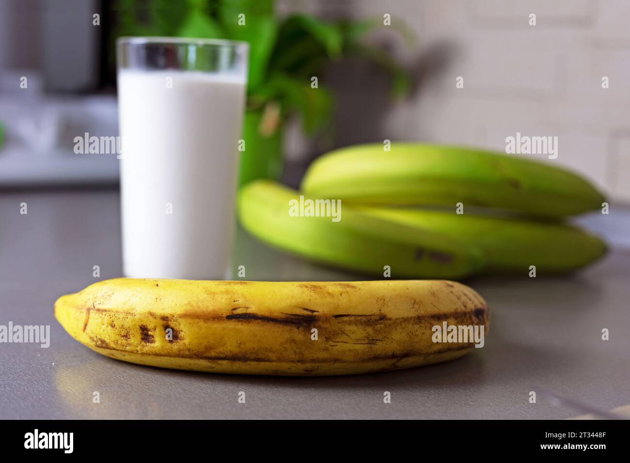 glass of banana milk next to a bunch of bananas Stock Photo - Alamy