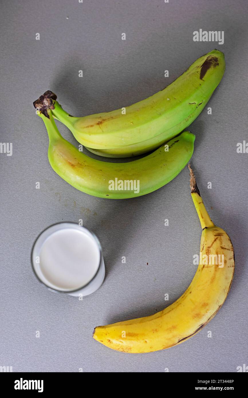 glass of banana milk next to a bunch of bananas Stock Photo - Alamy
